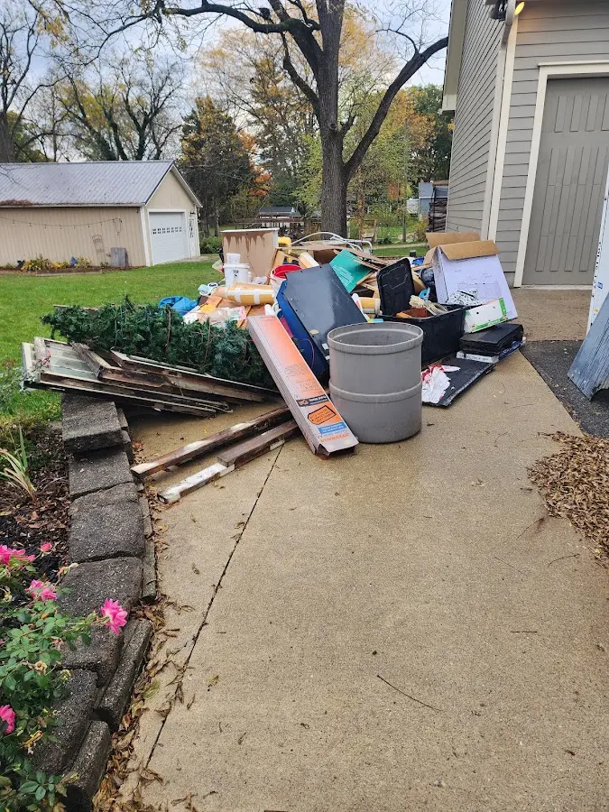 Dumpster being loaded with debris for Estate Cleanout Dumpster Rental in Ho-Ho-Kus